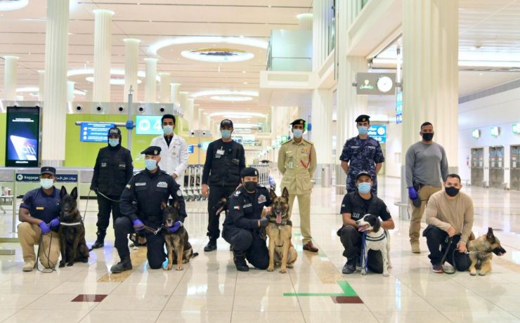a group of people with dogs in a building