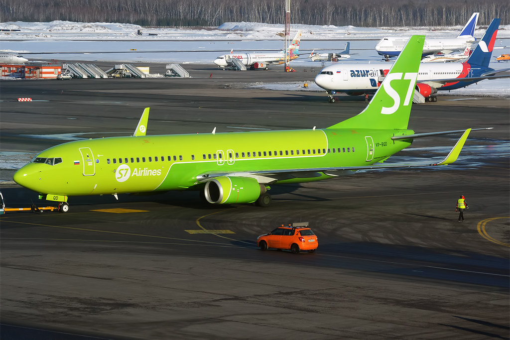 a green airplane on a runway
