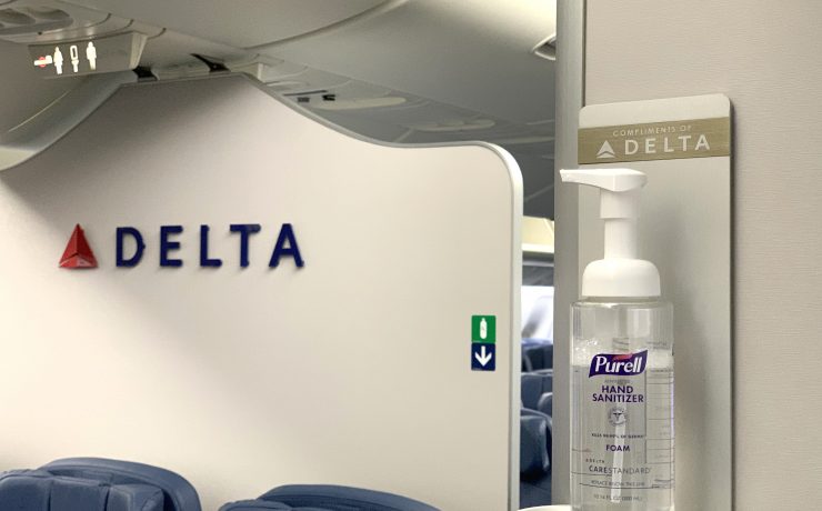 a hand sanitizer on a shelf in a plane