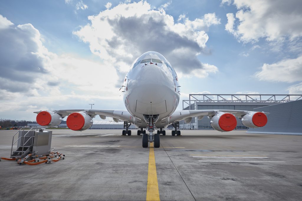 a large white airplane on a runway
