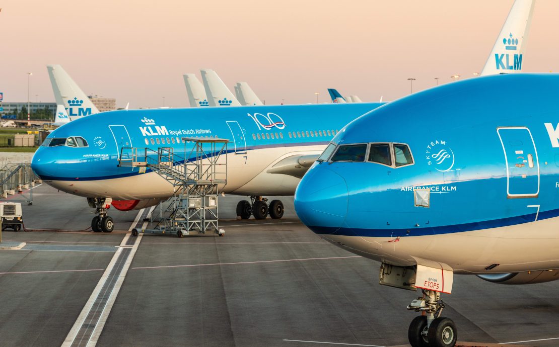a group of blue airplanes on a runway