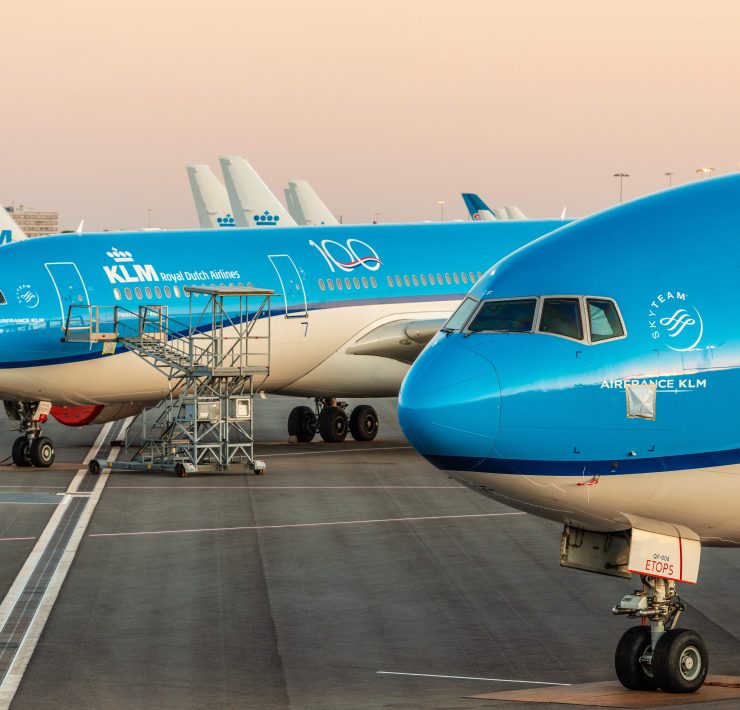 a group of blue airplanes on a runway