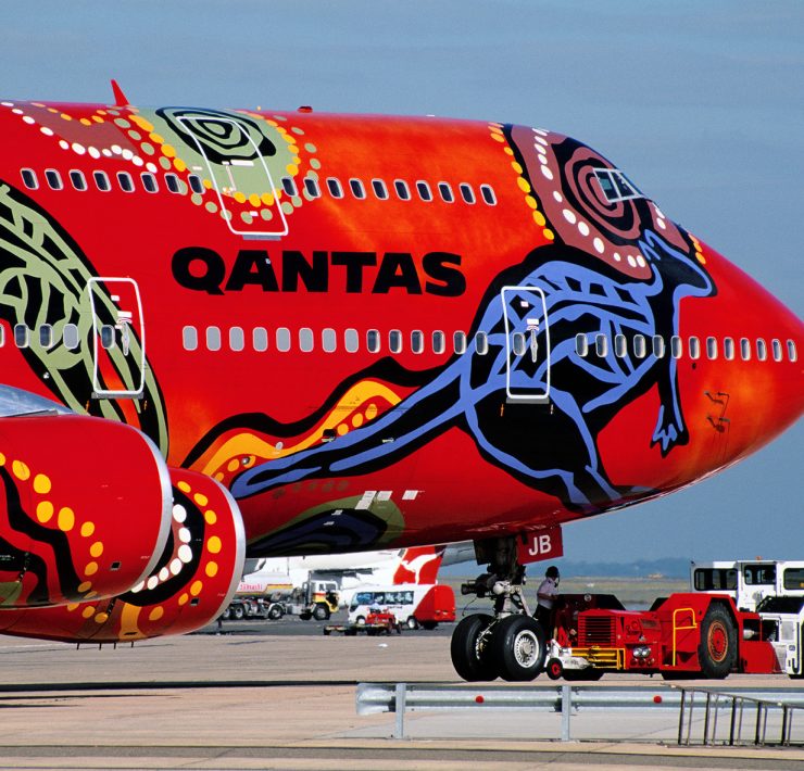 a red airplane with a colorful design on it
