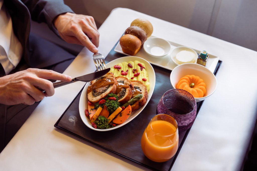 a person eating food on a tray