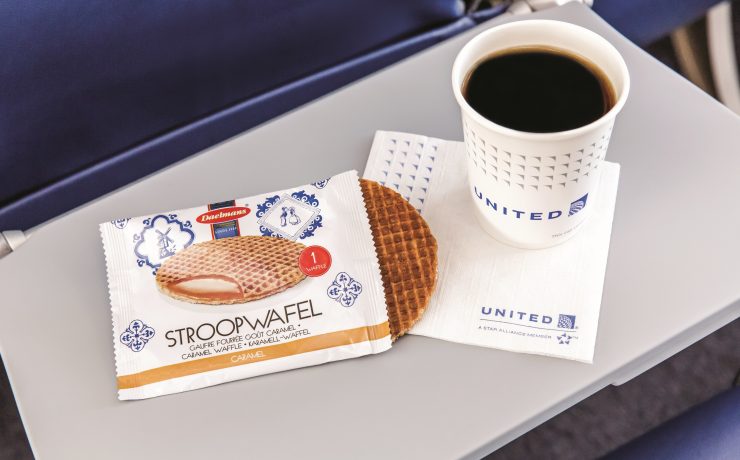 a cup of coffee and a bag of waffles on a table