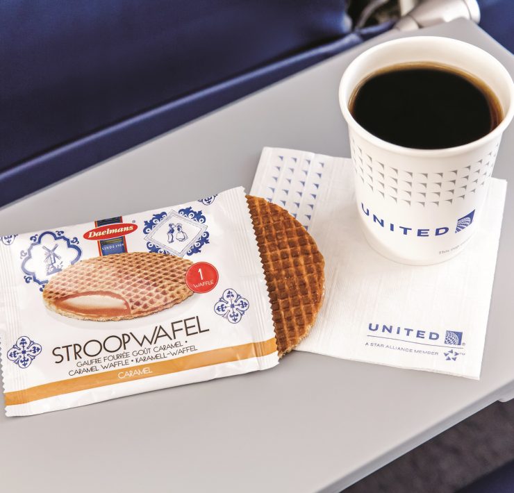 a cup of coffee and a bag of waffles on a table