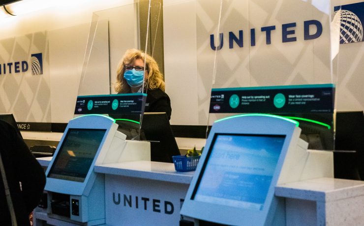 a woman wearing a mask behind a counter