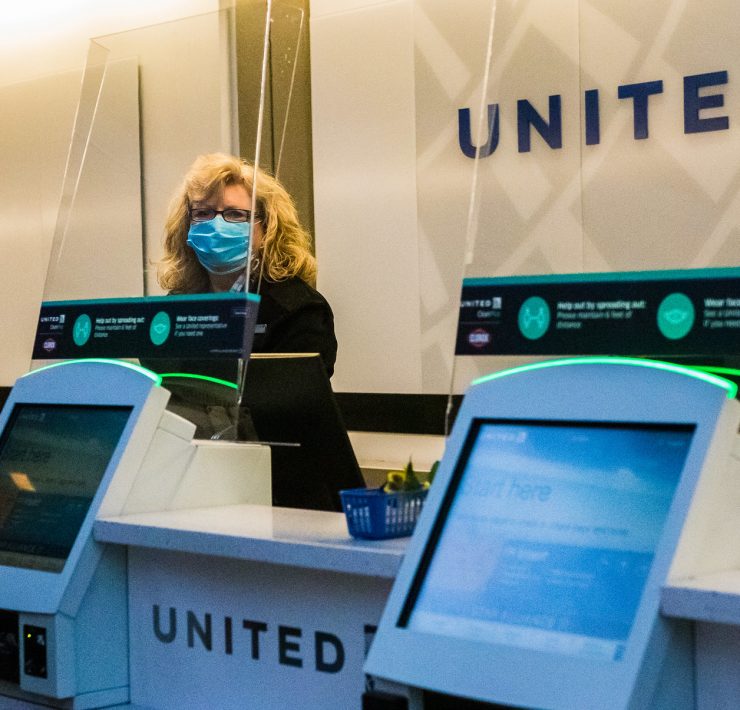 a woman wearing a mask behind a counter