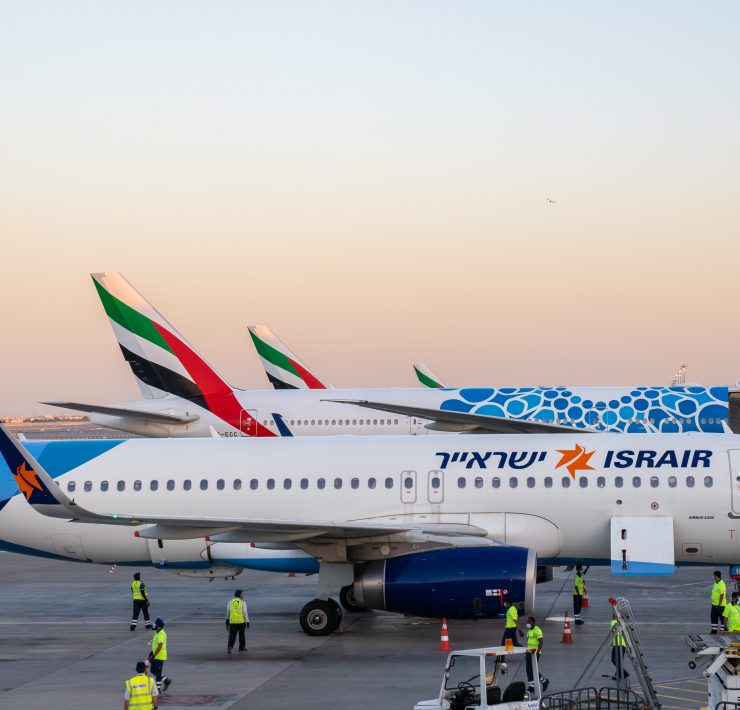 a group of airplanes parked on a runway