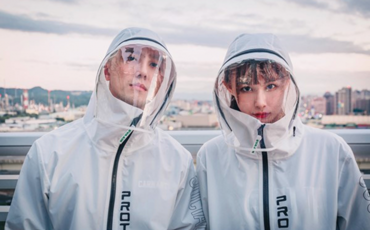 a man and woman wearing white raincoats
