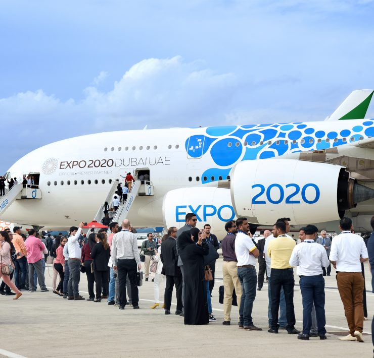 a group of people standing in front of an airplane