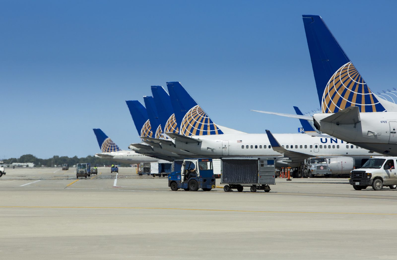 a group of airplanes parked on a runway