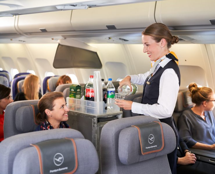 a woman serving drinks on an airplane
