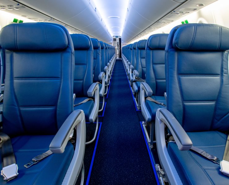 a row of blue seats on an airplane