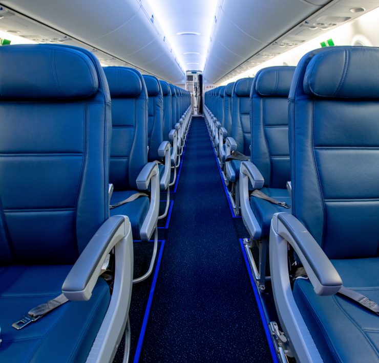 a row of blue seats on an airplane
