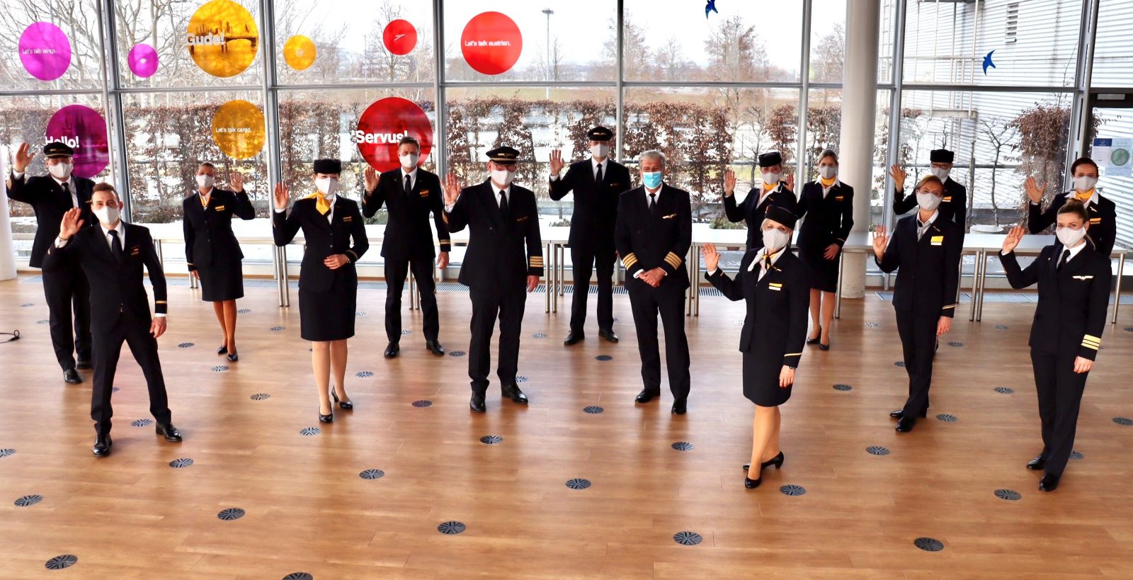 a group of people wearing face masks and standing in a room