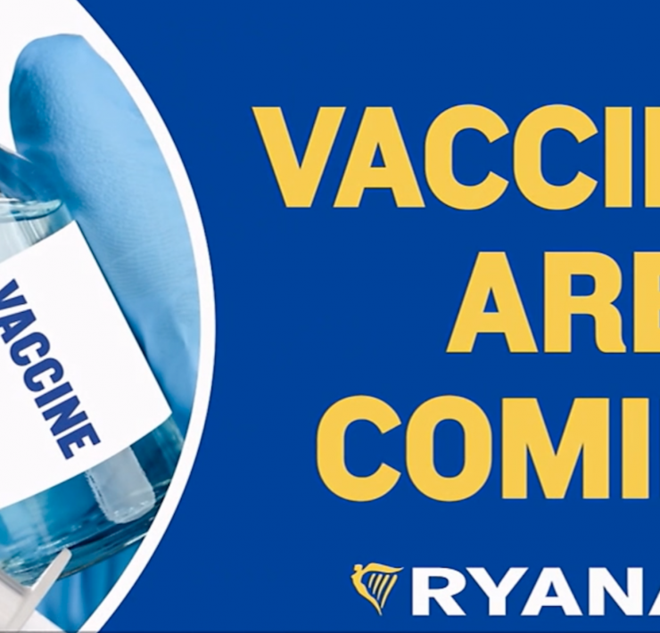 a hand holding a syringe with a vaccine