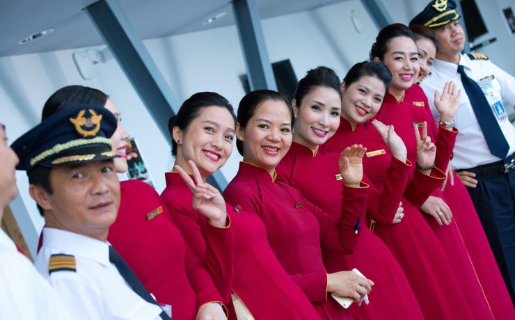 a group of women in red dresses