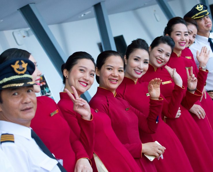 a group of women in red dresses