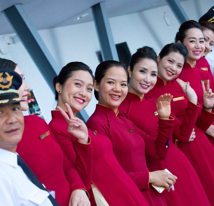 a group of women in red dresses