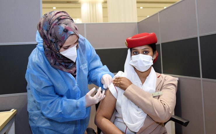 a woman in a medical uniform getting a shot of a patient