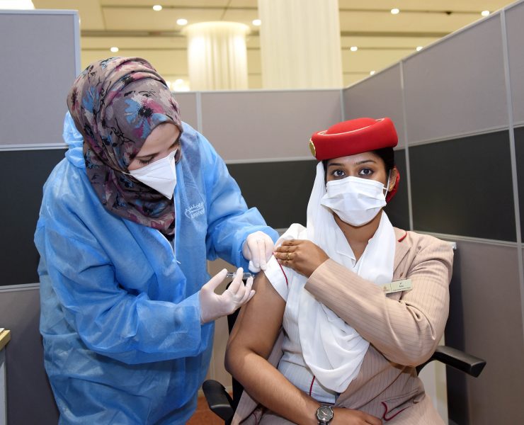 a woman in a medical uniform getting a shot of a patient