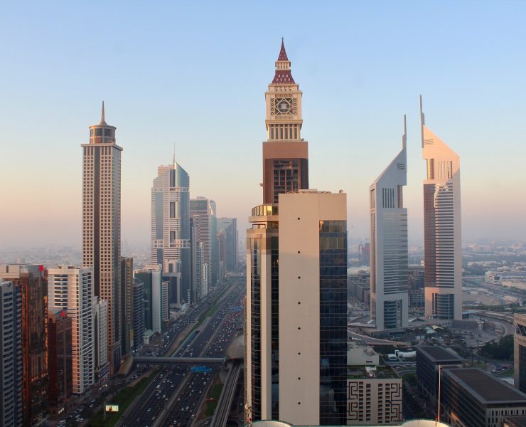a city with tall buildings and a clock tower