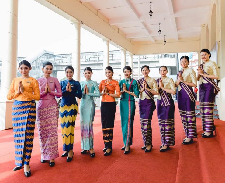 a group of women in colorful dresses