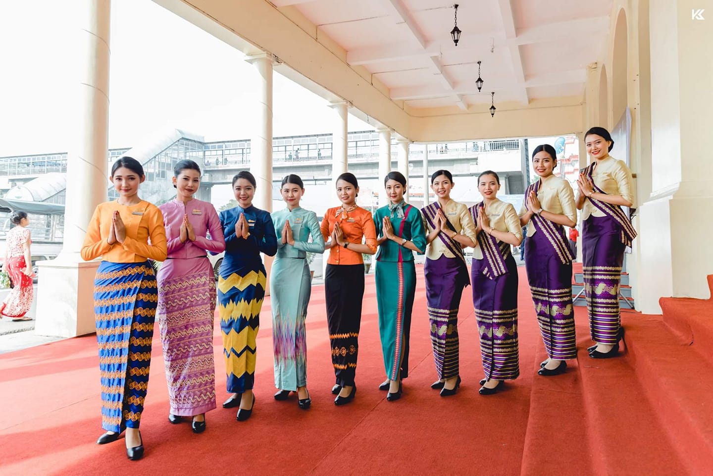a group of women in colorful dresses