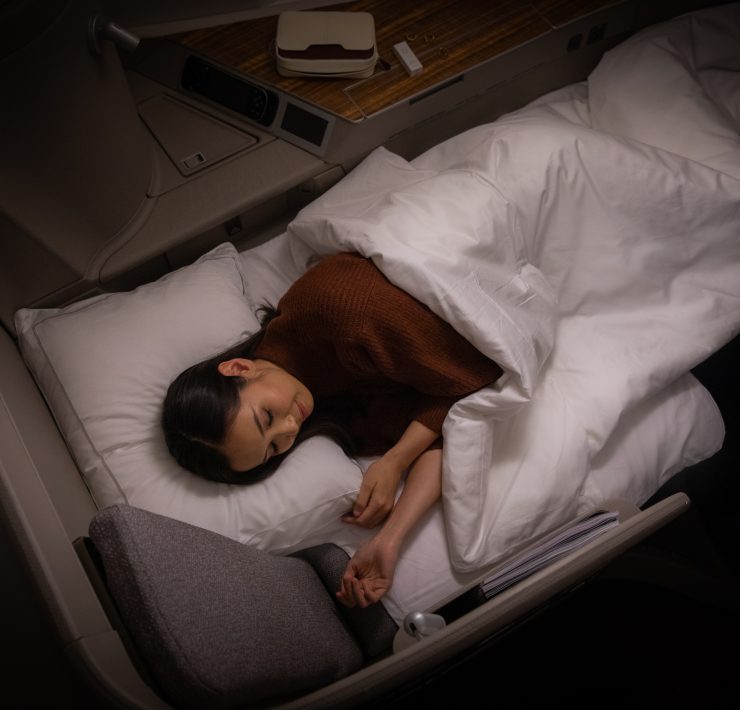 a woman sleeping in a bed