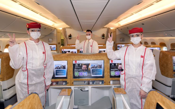 a group of people in white uniforms and face masks