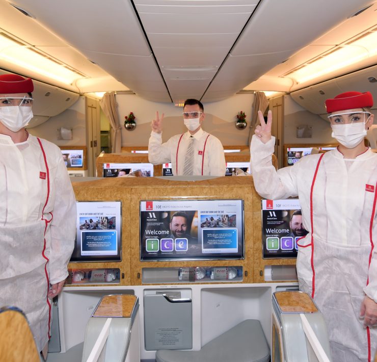 a group of people in white uniforms and face masks
