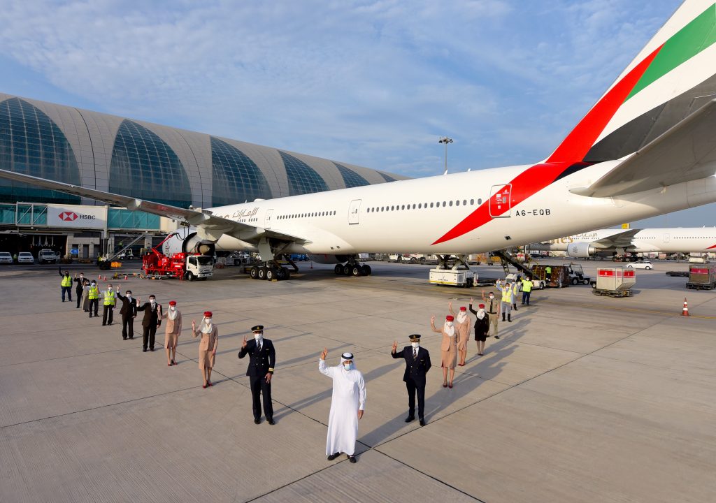 a group of people standing in front of a large airplane