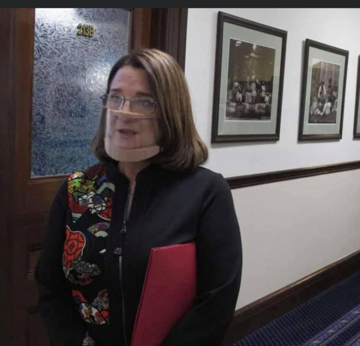 a woman with a bandage over her face