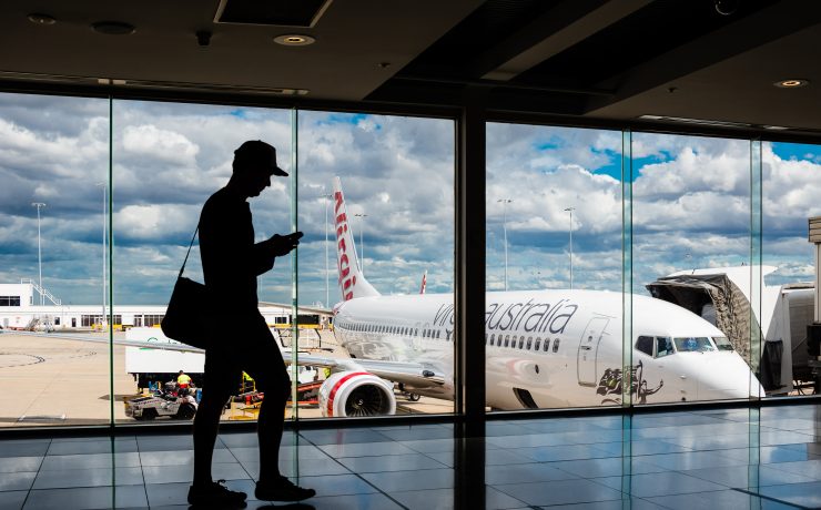 a man standing in front of a large window