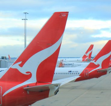 red and white airplanes with a white design on the tail