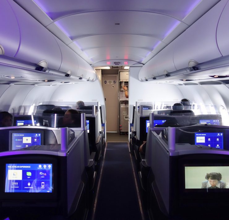 a row of seats with tvs on the side