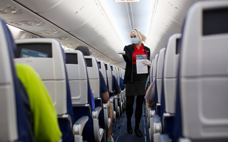 a woman wearing a mask on an airplane