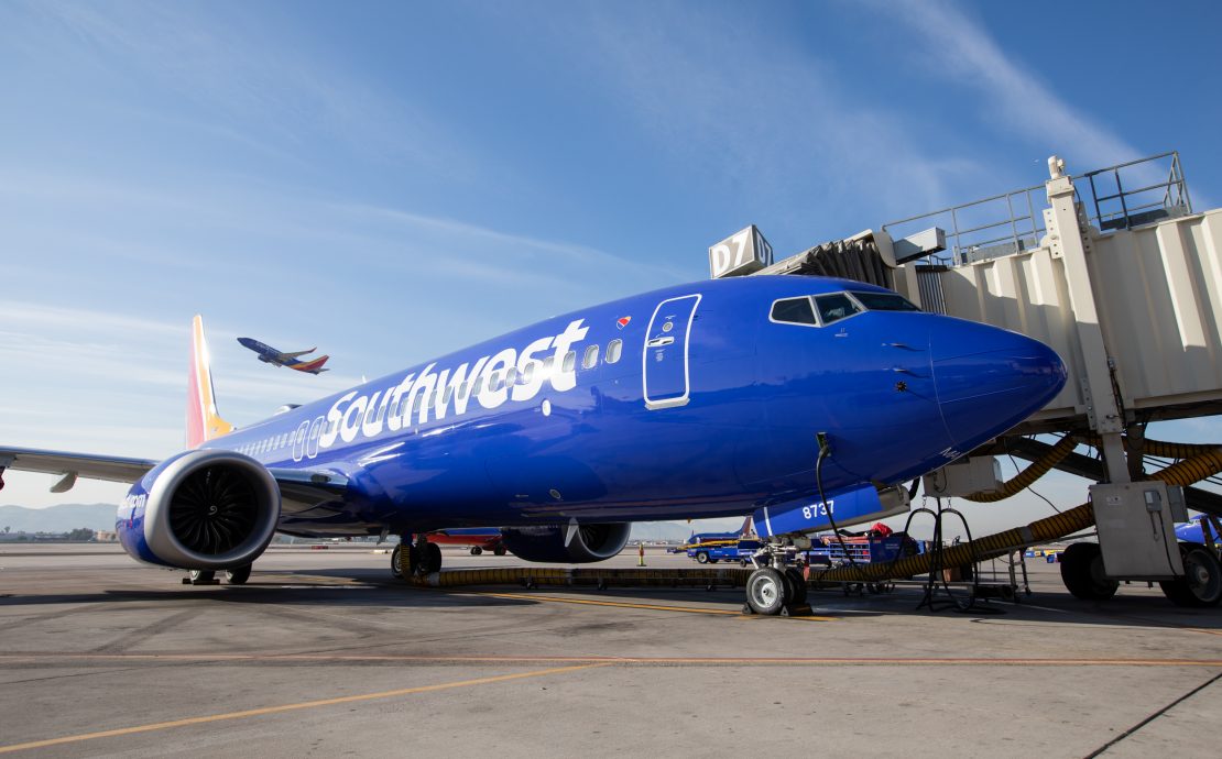a blue airplane on the tarmac