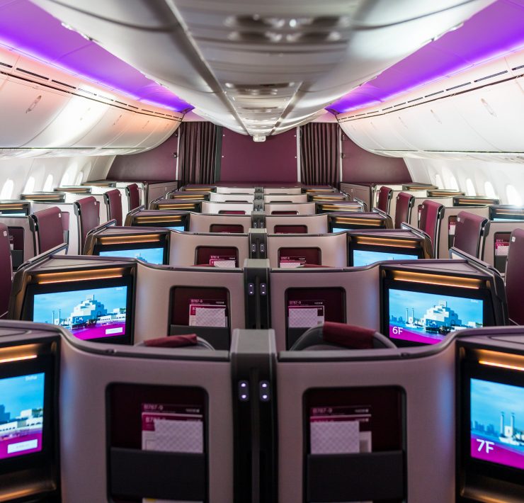 an airplane with rows of seats and monitors
