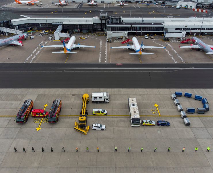 an airport with airplanes and trucks
