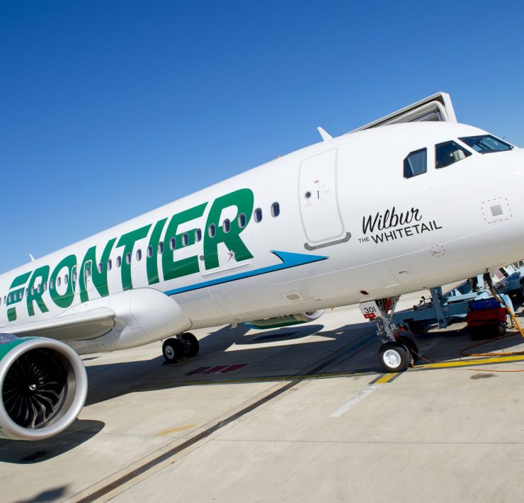 a white airplane with green writing on it