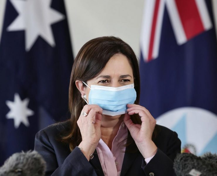 a woman putting on a face mask