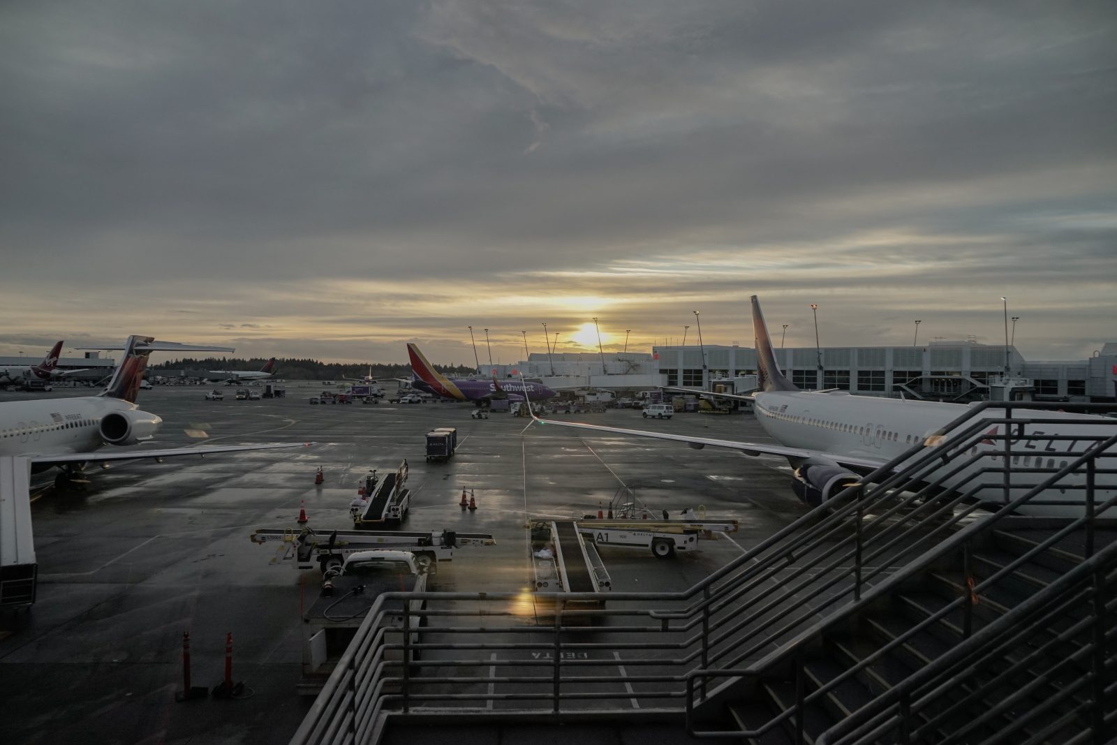 an airport with airplanes and stairs