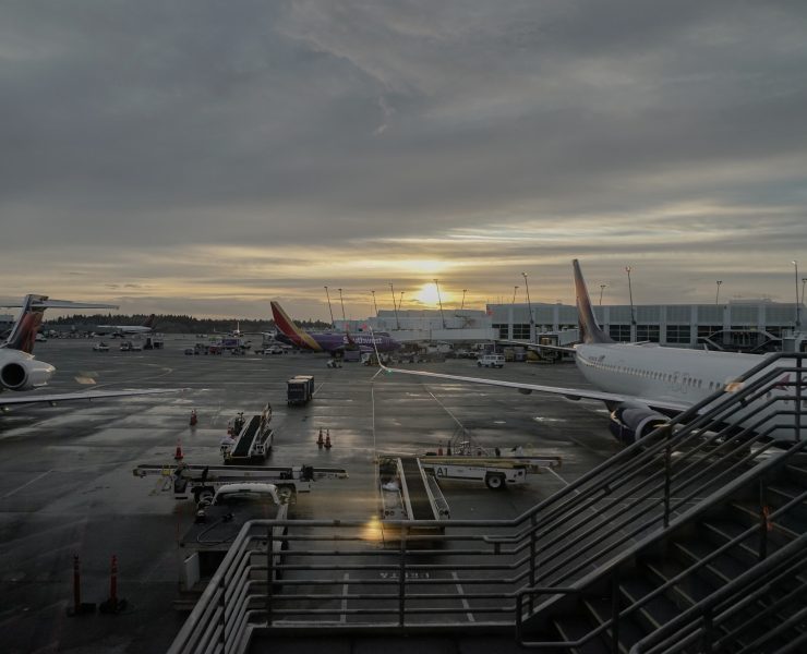 an airport with airplanes and stairs