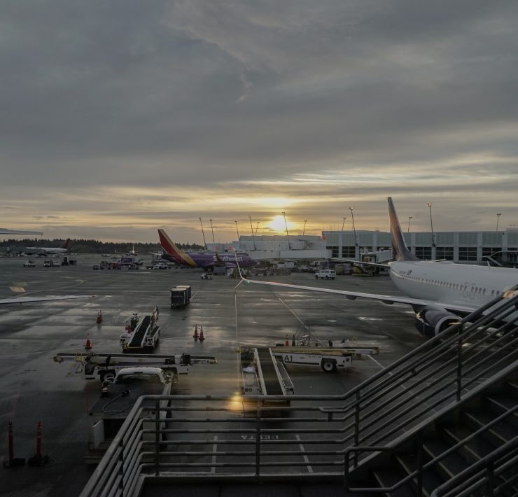 an airport with airplanes and stairs