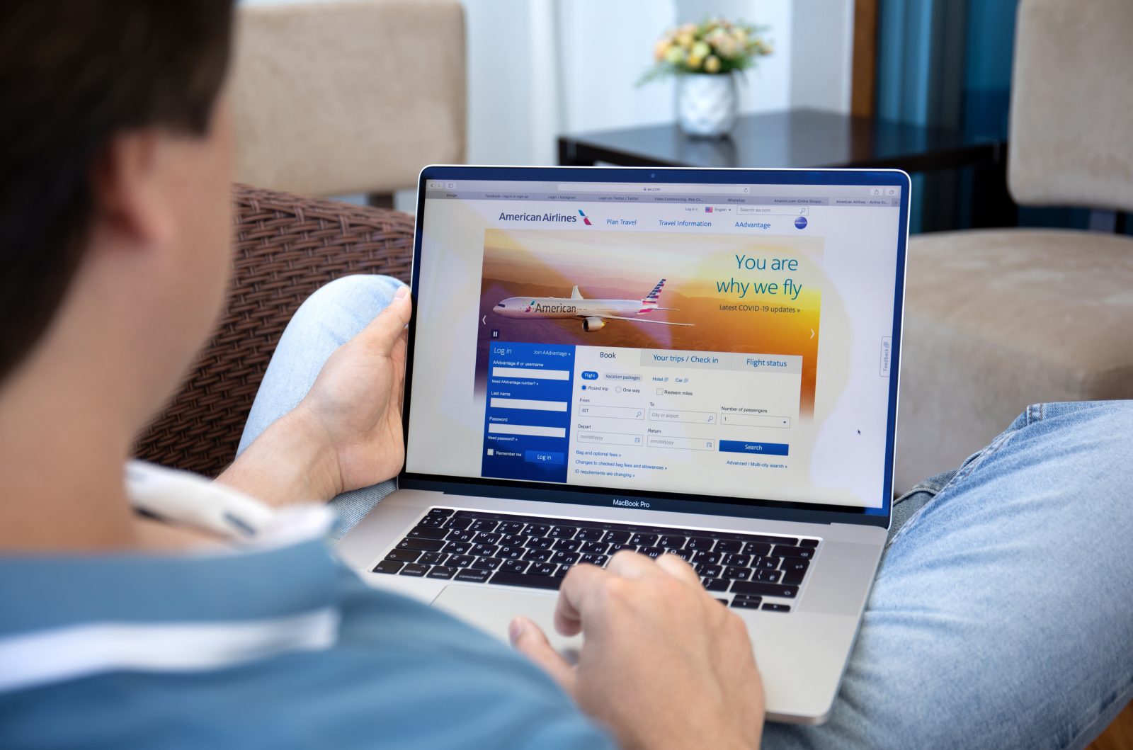 a person sitting in a chair using a laptop