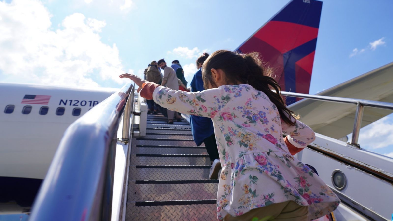 A young Afghan refugee boards a Delta Air Lines plane at Ramstein air force base in Germany bound for the United States