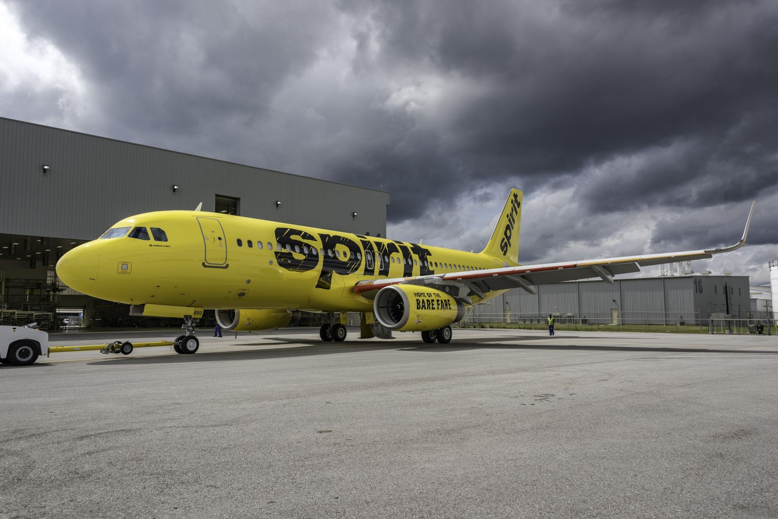 a yellow airplane parked on a tarmac