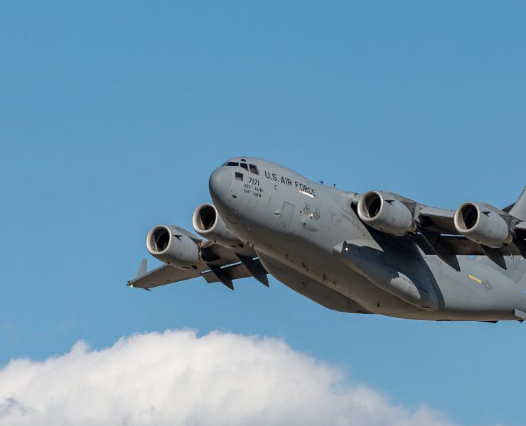 a large grey airplane flying in the sky